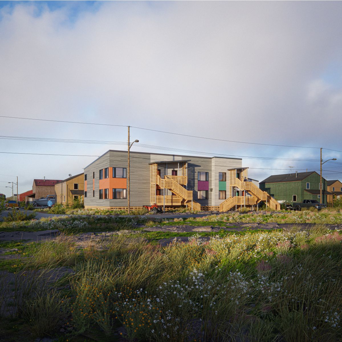 A 3D rendering of a sixplex with a wood paneled facade, flat roof, and exterior staircases leading to upper-level units. The structure features large windows, colorful accent panels, and covered entryways. The building is set in an open landscape with wild vegetation, power lines, and surrounding homes.